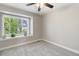Bedroom with neutral carpet, a ceiling fan, and a window overlooking a yard at 1462 Marigold Dr, Lafayette, CO 80026
