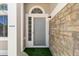 Inviting front entrance with a grey door, stone siding, and side windows allowing natural light to enter at 1462 Marigold Dr, Lafayette, CO 80026