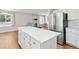 Bright kitchen with quartz island, stainless-steel appliances, and ample cabinet space at 1462 Marigold Dr, Lafayette, CO 80026