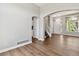 Bright and airy living room showcasing wood floors, arched doorways, and a staircase leading to the upper level at 1462 Marigold Dr, Lafayette, CO 80026