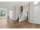 Spacious living room featuring wood flooring, a staircase, and large windows offering natural light and backyard views at 1462 Marigold Dr, Lafayette, CO 80026