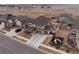 Aerial view of a home and community with a large yard and play area at 17077 E 111Th Ave, Commerce City, CO 80022