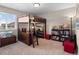 This charming bedroom features a built-in bunk bed, a desk, and shelving for storage and decor at 17077 E 111Th Ave, Commerce City, CO 80022