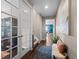 Inviting hallway with hardwood floors, a decorative rug, and bright natural lighting at 17077 E 111Th Ave, Commerce City, CO 80022