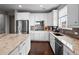 Well-equipped kitchen featuring granite countertops, stainless steel appliances, and sleek white cabinetry at 17077 E 111Th Ave, Commerce City, CO 80022