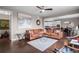 Bright living room featuring a comfortable brown sectional sofa and open access to the adjacent kitchen and dining area at 17077 E 111Th Ave, Commerce City, CO 80022