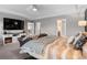 Relaxing main bedroom featuring a ceiling fan and views of an attached bathroom and staircase at 17077 E 111Th Ave, Commerce City, CO 80022