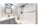 Modern bathroom features walk-in shower with dark and light gray tile, and a light gray vanity at 20091 E Bellewood Dr, Centennial, CO 80015