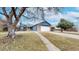 Charming home featuring brick accents, blue siding, mature trees, and a two-car garage at 20091 E Bellewood Dr, Centennial, CO 80015