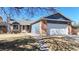 Charming home featuring brick accents, blue siding, mature trees, and a two-car garage at 20091 E Bellewood Dr, Centennial, CO 80015