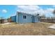 Back exterior of the home featuring blue siding, several windows and a fenced-in yard at 20091 E Bellewood Dr, Centennial, CO 80015