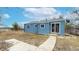 Back exterior of the home featuring blue siding, sliding glass door and fenced-in yard at 20091 E Bellewood Dr, Centennial, CO 80015