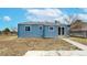 Back exterior of the home featuring blue siding, sliding glass door and fenced-in yard at 20091 E Bellewood Dr, Centennial, CO 80015