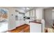 Efficient kitchen with white cabinets, a breakfast bar, and modern appliances at 20091 E Bellewood Dr, Centennial, CO 80015