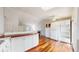 Spacious kitchen with custom wood countertops, white cabinetry, and hardwood floors adjacent to the living area with fireplace at 20091 E Bellewood Dr, Centennial, CO 80015