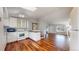 Open floor plan featuring hardwood floors, white cabinets, and stainless appliances at 20091 E Bellewood Dr, Centennial, CO 80015