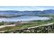 An aerial view showcasing a picturesque lake and mountain range in the distance at 8022 S Jay Dr, Littleton, CO 80128