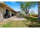 Spacious backyard with a patio, lush greenery, and mature trees providing shade at 8022 S Jay Dr, Littleton, CO 80128