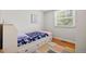 Bright bedroom with hardwood floors and a daybed with drawers at 8022 S Jay Dr, Littleton, CO 80128
