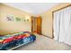 Bedroom with colorful bedding and posters and lots of space at 8022 S Jay Dr, Littleton, CO 80128