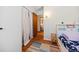 Bright bedroom featuring a bed, wood floors, a patterned rug, and natural light at 8022 S Jay Dr, Littleton, CO 80128
