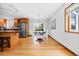 Bright dining area with backyard views, hardwood floors, and pendant lighting at 8022 S Jay Dr, Littleton, CO 80128
