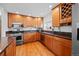 Kitchen features wood cabinets, stainless steel appliances, and ample counter space at 8022 S Jay Dr, Littleton, CO 80128