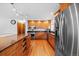 Well-equipped kitchen featuring stainless steel appliances, wood cabinets and granite countertops at 8022 S Jay Dr, Littleton, CO 80128