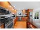 Kitchen features wood cabinets, stainless steel appliances, and ample counter space at 8022 S Jay Dr, Littleton, CO 80128