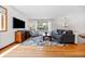 Cozy living room with natural light, hardwood floors, and comfortable seating at 8022 S Jay Dr, Littleton, CO 80128