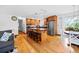 Open concept features stainless appliances, island, seating, and backyard views at 8022 S Jay Dr, Littleton, CO 80128