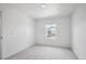 Bright bedroom featuring neutral carpet, a window with a view, and white walls at 22363 E 6Th Pl, Aurora, CO 80018