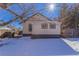 The home's backyard features a snow covered lawn at 202 Lower Glenway St, Palmer Lake, CO 80133