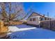 The home's backyard features a snow covered lawn at 202 Lower Glenway St, Palmer Lake, CO 80133