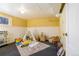 Finished basement area is set up as a playroom with toys, a teepee, and a colorful rug at 202 Lower Glenway St, Palmer Lake, CO 80133