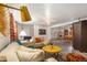 Finished basement with multiple seating areas, decor, and a foosball table at 202 Lower Glenway St, Palmer Lake, CO 80133