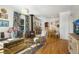 Cozy living room with hardwood floors, comfortable seating, and stylish décor, and connecting dining area at 202 Lower Glenway St, Palmer Lake, CO 80133