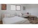 Bright bedroom area featuring modern decor, a bed, and a sofa with stylish accents at 2415 Urban St, Lakewood, CO 80215