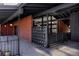 Mid-century modern home exterior with brick accents, black beams and breezeway at 2415 Urban St, Lakewood, CO 80215