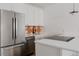 Modern kitchen with white cabinets, stainless steel appliances, and modern countertops at 2415 Urban St, Lakewood, CO 80215