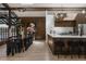 Contemporary kitchen and dining area featuring wood cabinetry, white countertops, and modern decor at 2415 Urban St, Lakewood, CO 80215