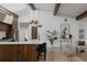 Bright kitchen with a large island, modern lighting, and an adjoining open living area at 2415 Urban St, Lakewood, CO 80215