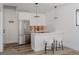 Modern kitchen with white cabinets, stainless steel appliances, and a stylish breakfast bar at 2415 Urban St, Lakewood, CO 80215