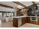 Open kitchen showcases stainless steel appliances, wooden cabinets, white countertops and breakfast bar at 2415 Urban St, Lakewood, CO 80215