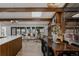 Open living space with wood beams, modern kitchen, stone fireplace and stylish furnishings at 2415 Urban St, Lakewood, CO 80215