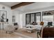 Living room features wood beam ceilings, neutral color scheme, and access to the outdoor patio at 2415 Urban St, Lakewood, CO 80215