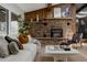 Cozy living room area featuring a stone fireplace, comfortable seating and stylish decor at 2415 Urban St, Lakewood, CO 80215