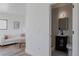Living room flows to an ensuite bathroom with modern fixtures and gray tiling at 2415 Urban St, Lakewood, CO 80215