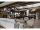 Open living space features wood beam ceilings and modern finishes connecting to the kitchen and dining area at 2415 Urban St, Lakewood, CO 80215