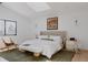 Bright main bedroom with skylight, hardwood floors, large window, and neutral decor at 2415 Urban St, Lakewood, CO 80215
